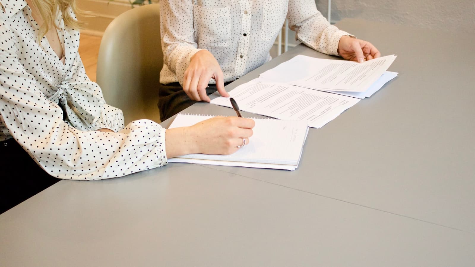 Projektledare och entreprenör går igenom kontraktshandlingar på ett bygge